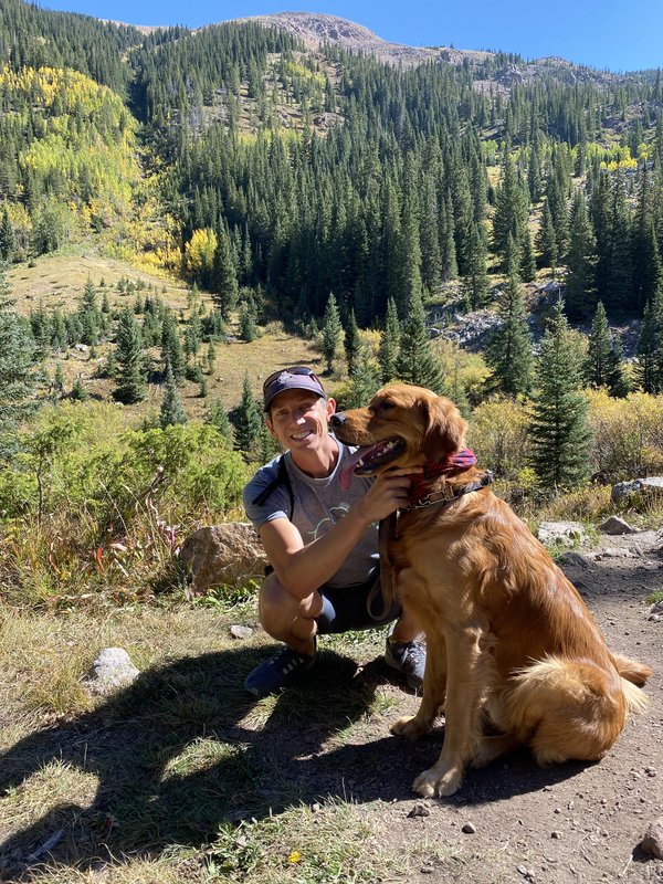 Josh and Scout hiking in the aspens